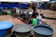 مدينة زامبوانغا. نازحون في ملعب خواكين إنريكي يجلبون المياه النظيفة من صنابير مياه أقامتها اللجنة الدولية.
