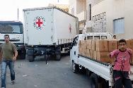 ICRC vehicles deliver emergency aid for distribution by the Syrian Arab Red Crescent. 