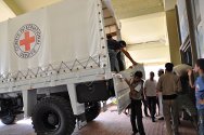 Ras Lanuf, Libya. Food and hygiene kits are unloaded from ICRC trucks. The kits will be distributed to approximately 1,100 people.