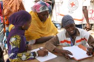 Senegal. RFL activities at the Grand Magal, Touba, 2011. A volunteer filling in a search form for a mother.