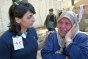 Photo, A delegate from the International Federation providing psychological support for a woman who lost her home during the earthquake that devastated parts of Algeria in 2003.
