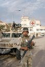 Photo, US soldiers patrolling the streets of Baghdad near the ICRC delegation in 2003.