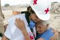 Photo, A Peruvian Red Cross volunteer comforting a victim of a mudslide caused by El Niño.
