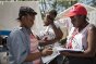 An ICRC employee and a Haitian Red Cross volunteer interview a woman in Port-au-Prince, to help reunite her with her child.