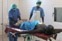 South Sudan, Upper Nile state, Malakal Regional Hospital. A patient suffering from a compound leg fracture has his leg reset by surgeons.