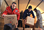 Bludan, Syria. Local people help SARC volunteers unload food parcels from trucks in the main square, at an improvised warehouse donated by a local businessman.