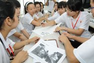 Nanjing, China. Young people taking part in an interactive Exploring Humanitarian Law activity as part of a Red Cross Society of China summer camp