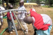 Photo, Kenya, Rift Valley. Children drinking from the tap of an ICRC-installed standpipe.