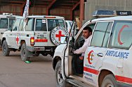 Aéroport de Koufra, Libye. Des ambulances et des véhicules du CICR attendent de pouvoir transférer des blessés dans l'avion qui les transportera à Tripoli.