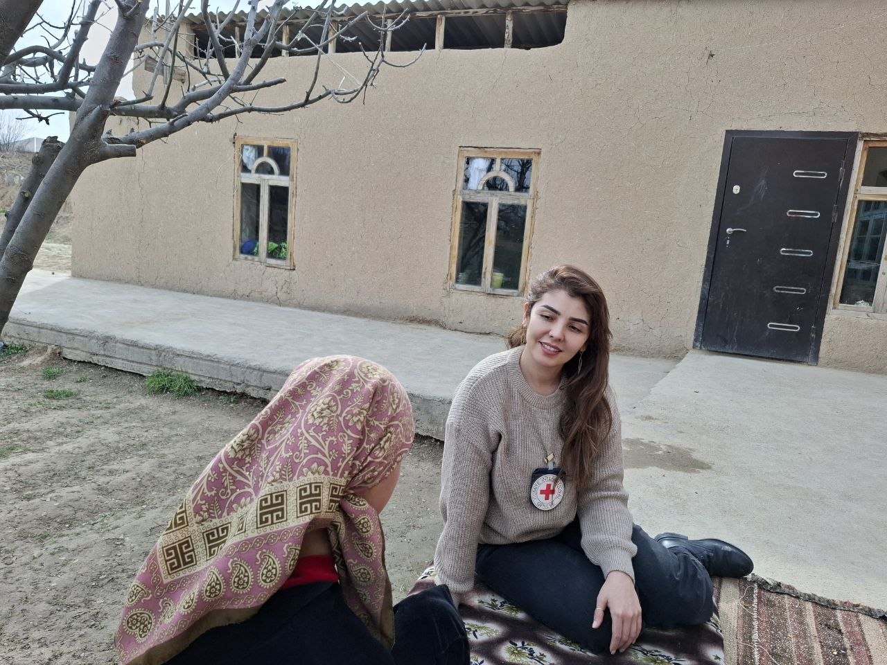 Maryam takes part in a psychological support session at home during a follow-up visit in Tajikistan.