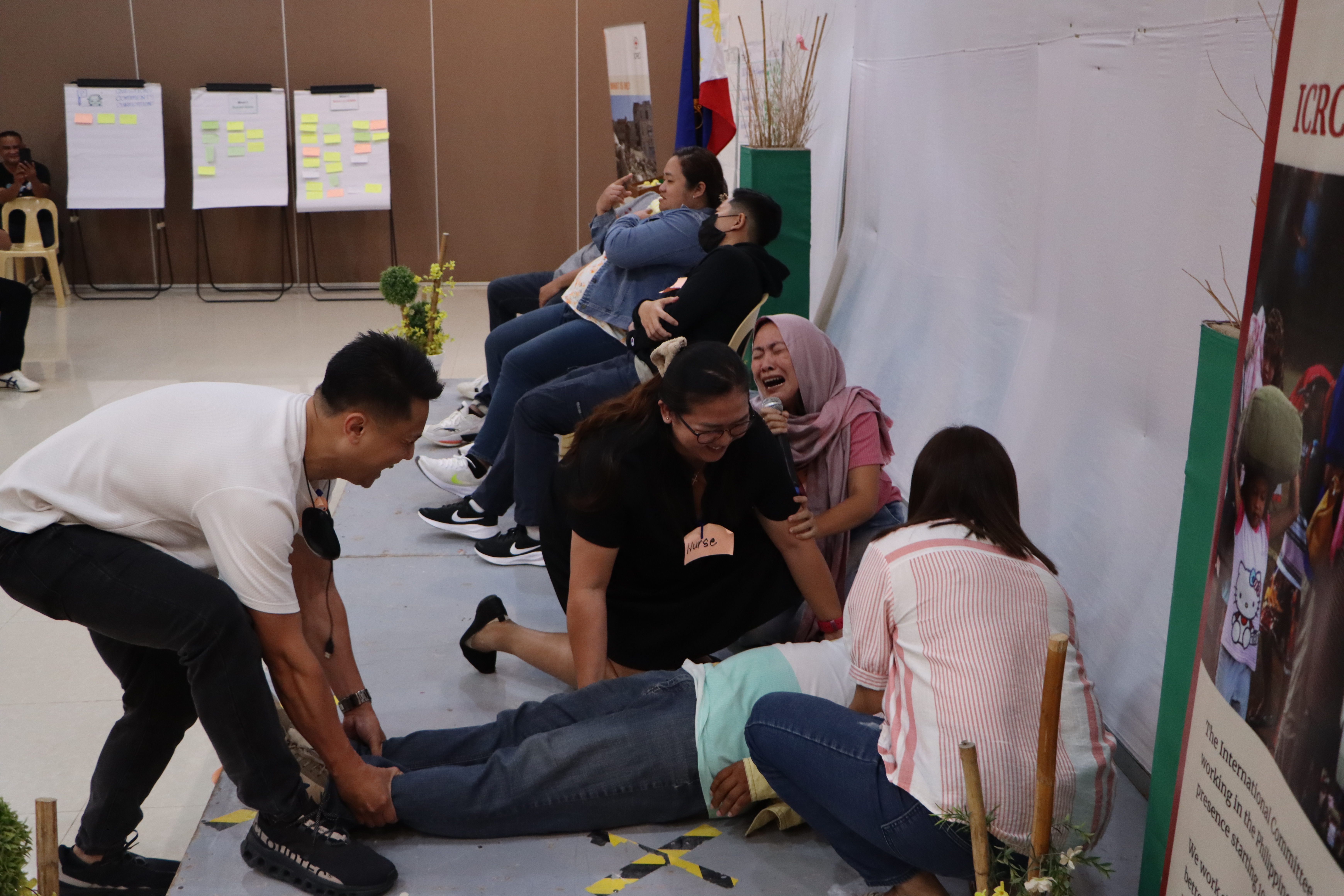 Healthcare workers in Mindanao participated in a role-play activity to demonstrate how best to manage situations when faced with stress, threats, and physical violence. Photo: M. Lucero/ICRC.