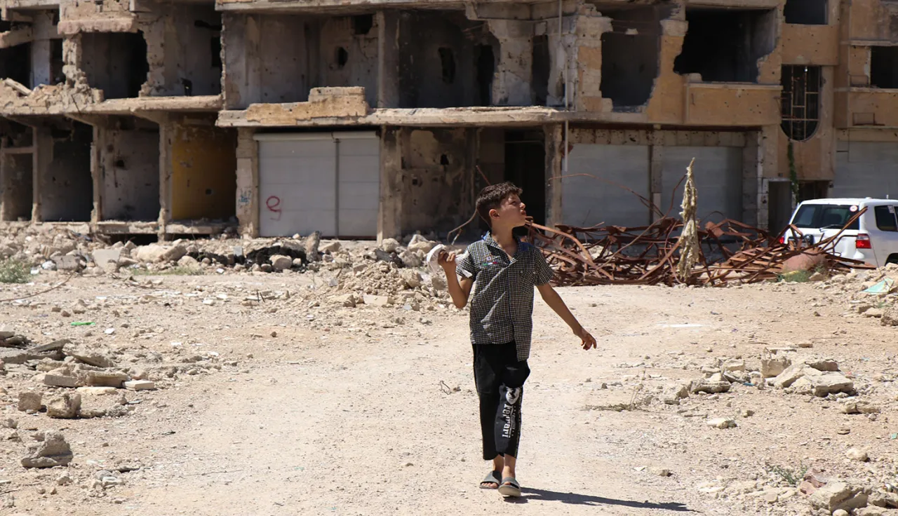 Child walking the rubble in Syria.