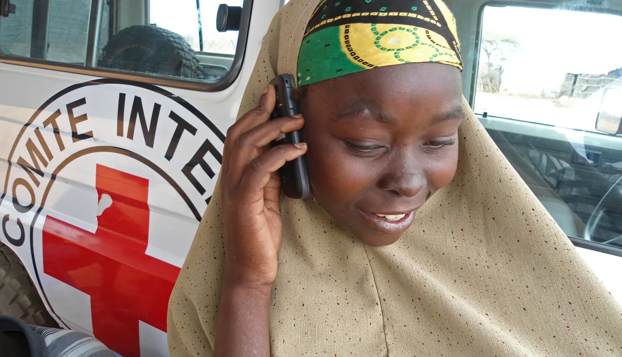 A Somali woman phones a relative in Dadaab refugee camp, Kenya.