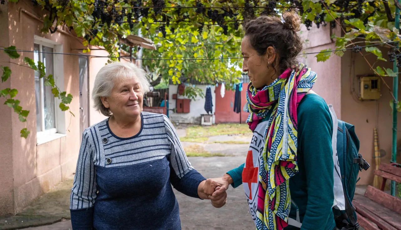 A nurse assists an elderly woman in the Kherson region of Ukraine.