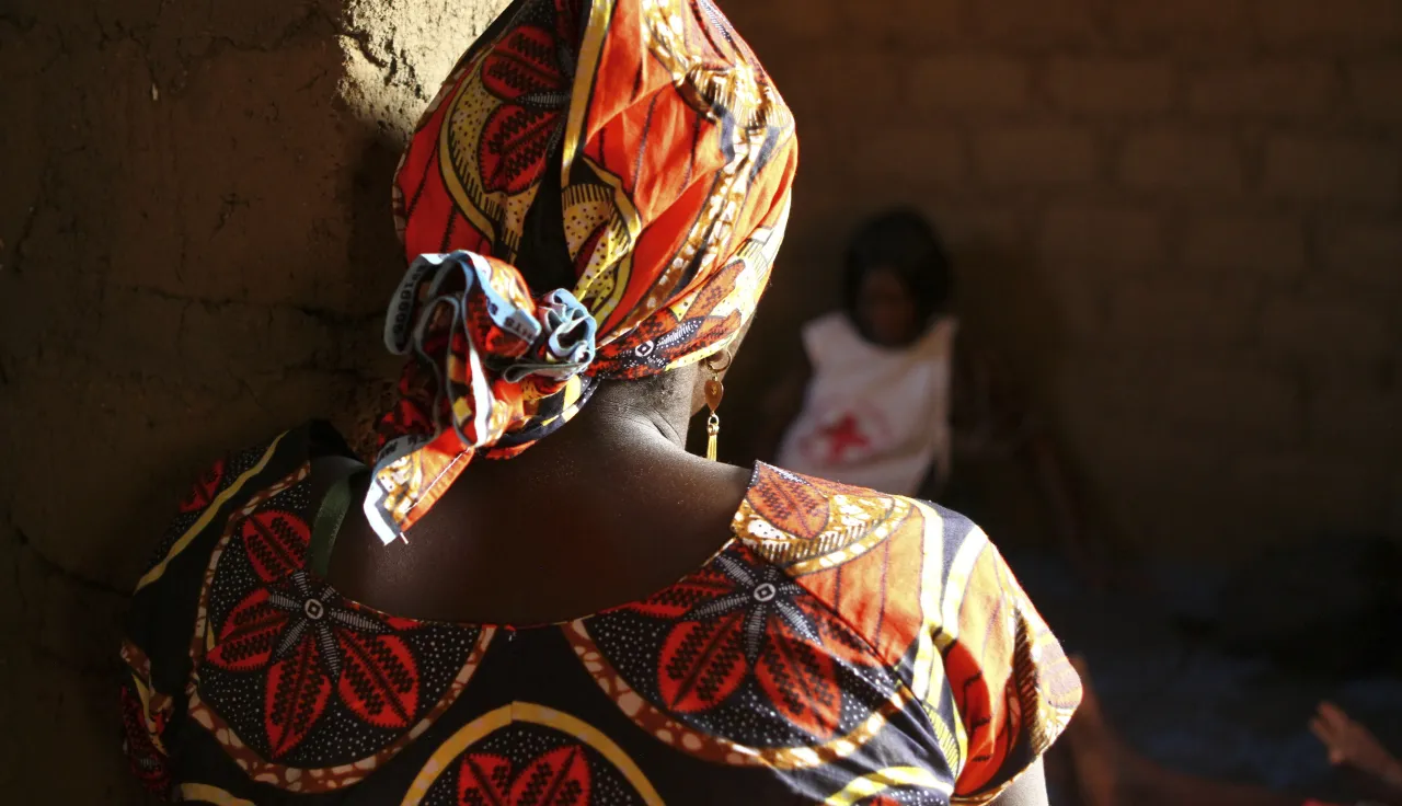 An ICRC staff member listens to the story of a woman who experienced depression after her husband was killed by an armed group. 