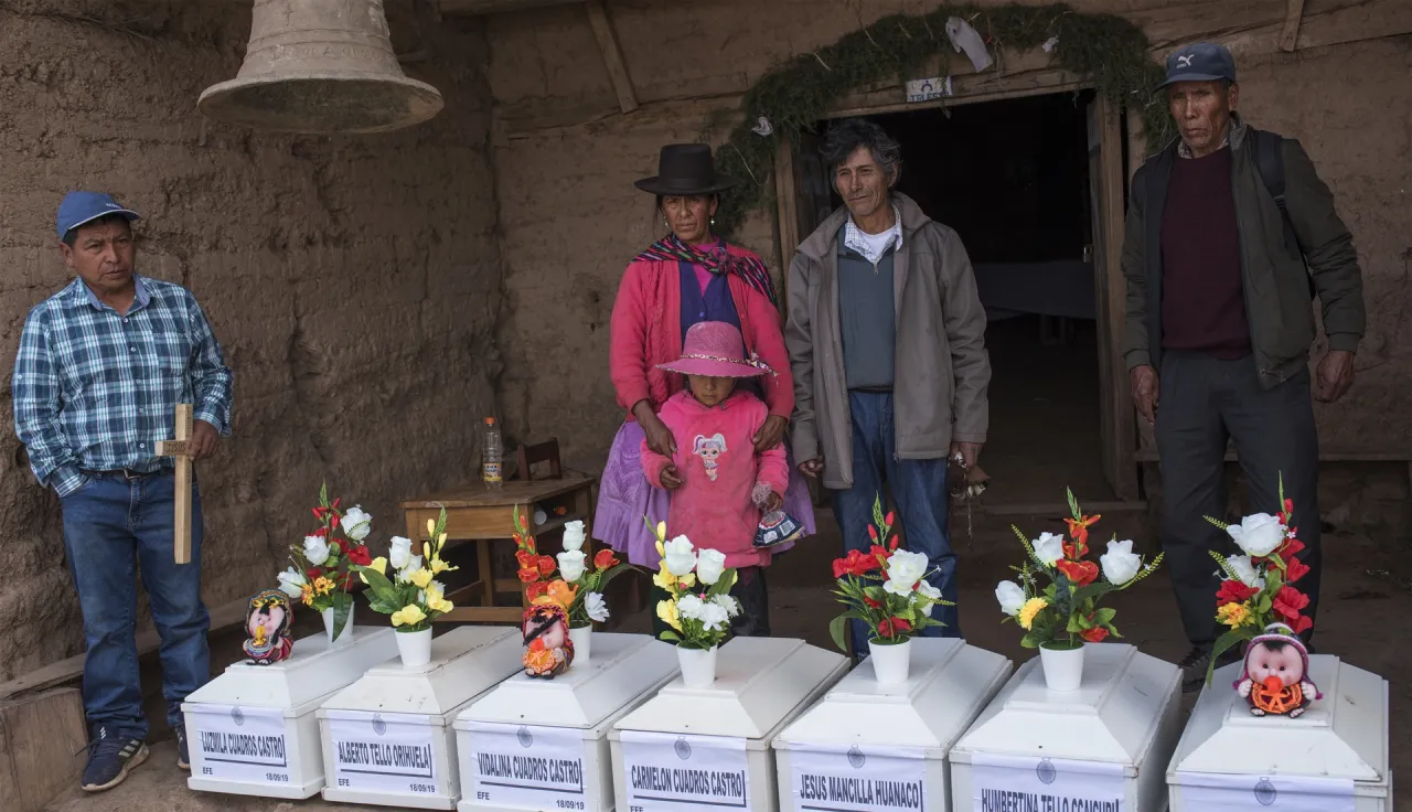 In Peru, relatives of individuals missing for 30 years ceremoniously bury 12 individuals whose remains have been found and identified. 