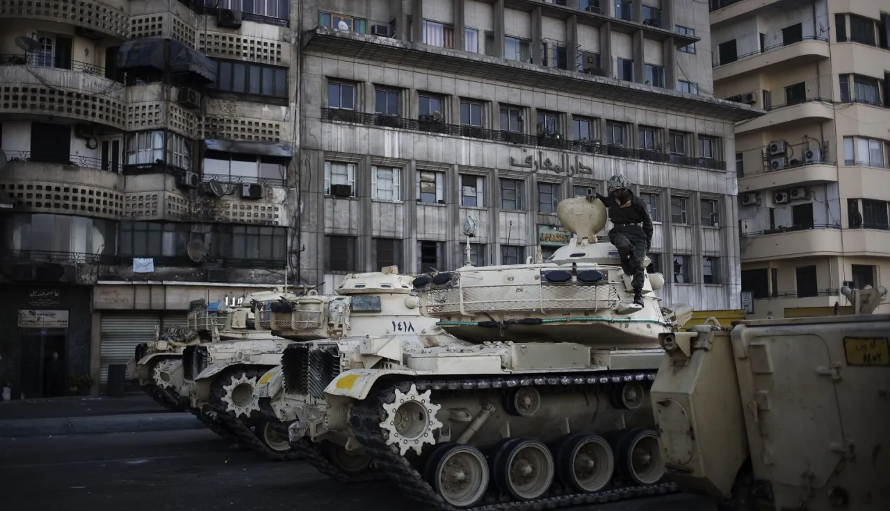 An Egyptian soldier getting out of his tank in the area used for Pro-Mubarak supporters