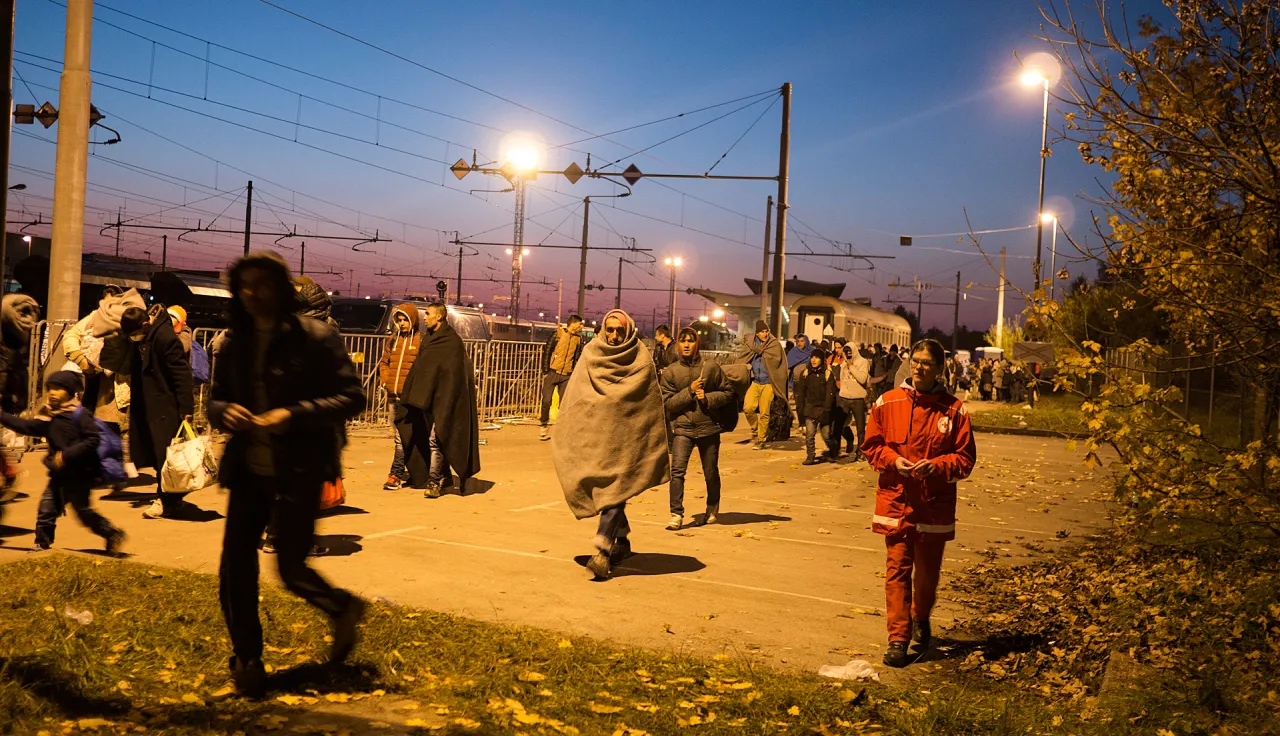 Slovenian Red Cross members with refugees and migrants in transit.