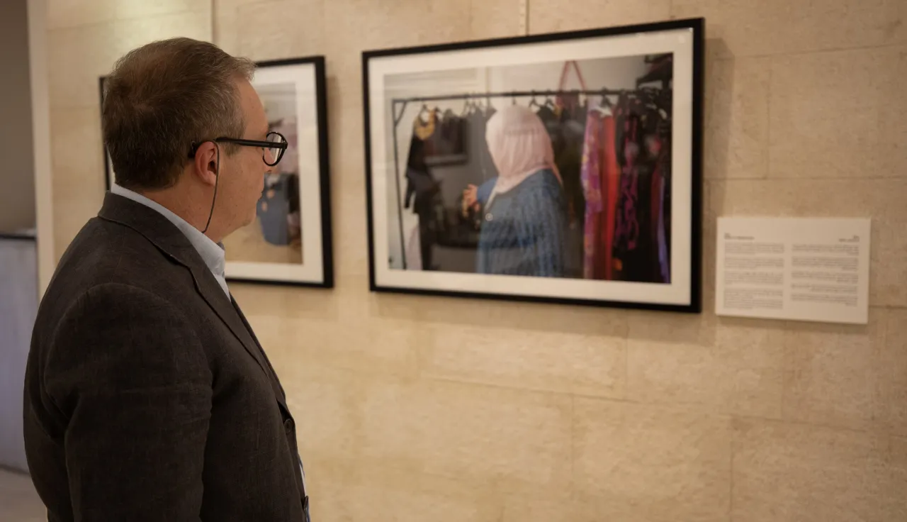 Man looking at images on display at Jordan's International Day of the Disappeared conference held in Amman.