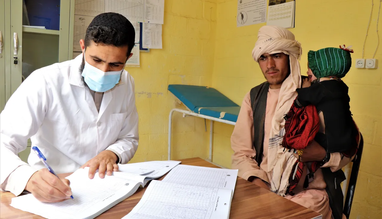 A healthcare worker providing consultation to a patient in Farah, Afghanistan A healthcare worker providing consultation to a patient in Farah, Afghanistan