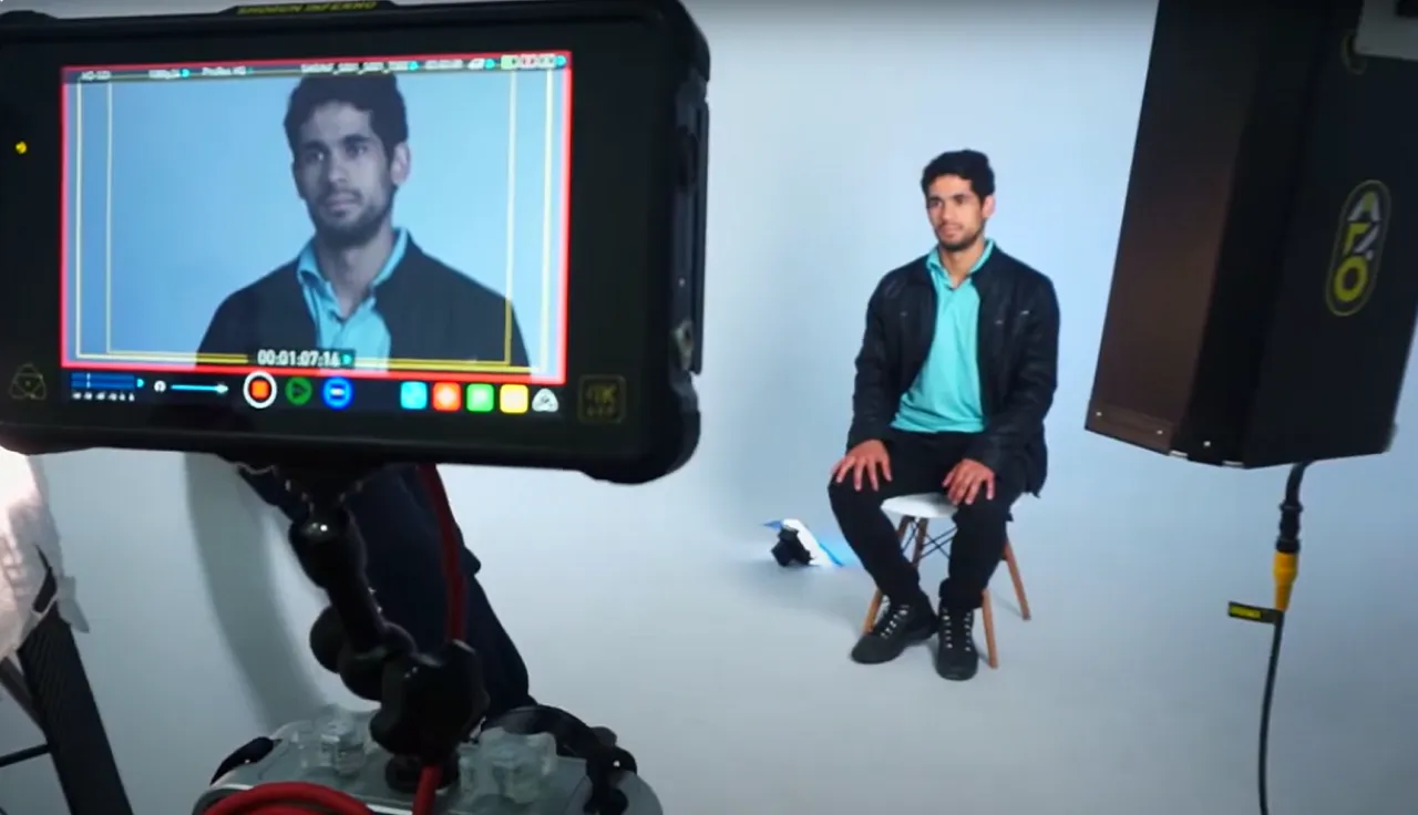 Un joven siendo filmado en un estudio.