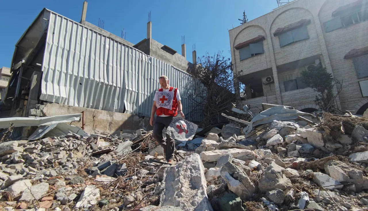 ICRC staff assessing a collapsed building