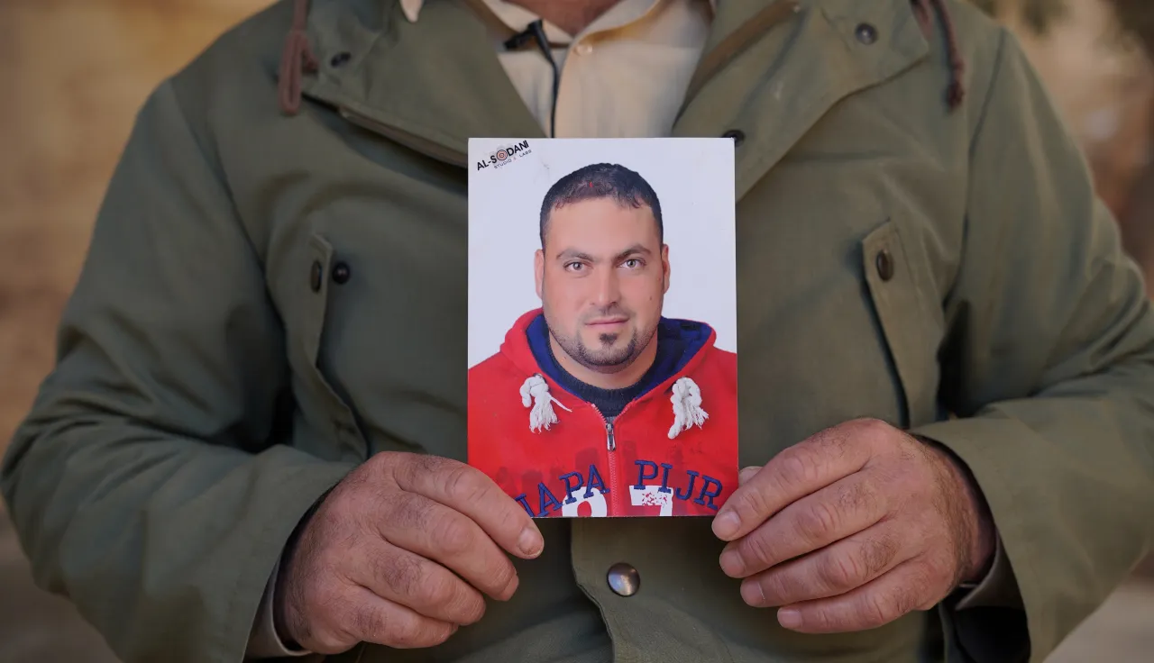 A brother of Family of missing holding his picture