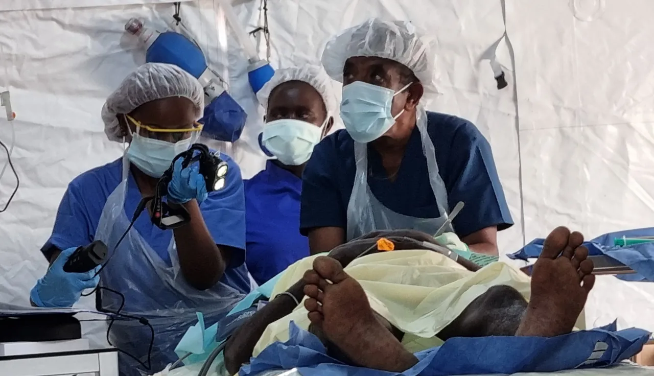 Surgeons treating a patient