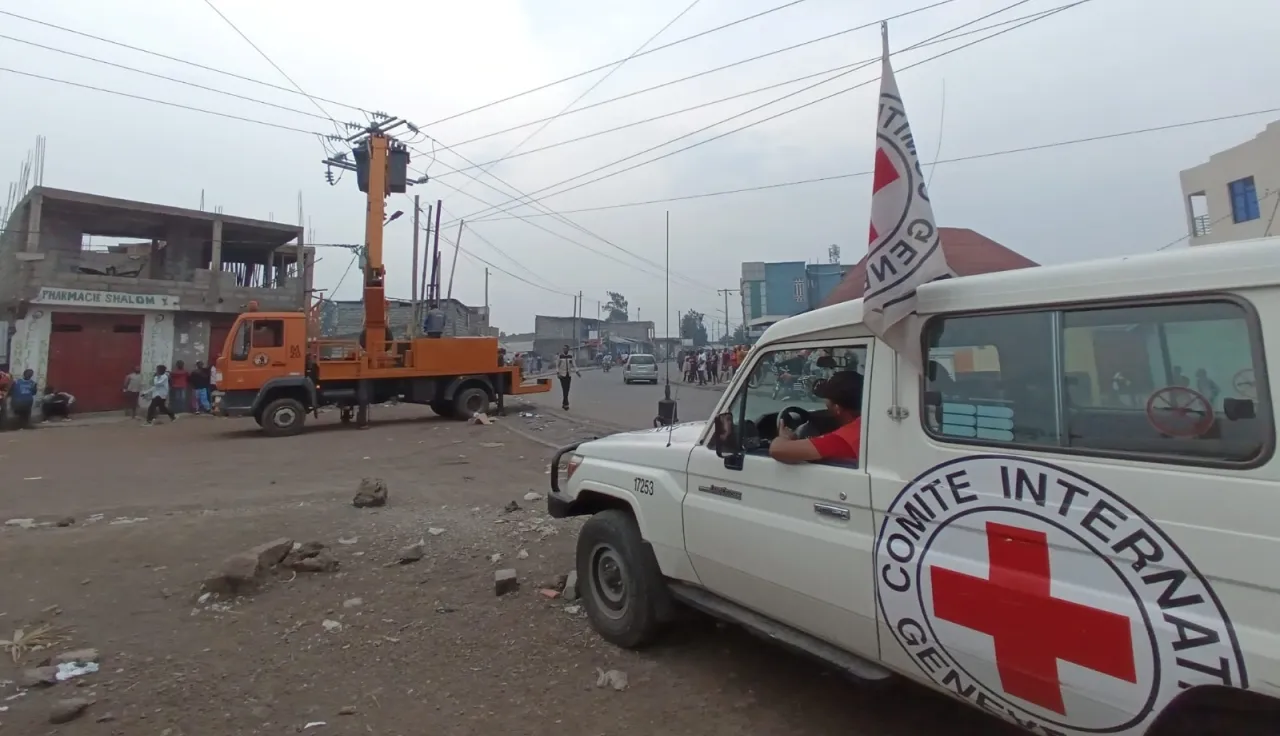 ICRC landcruiser next to electricity pylons in Goma