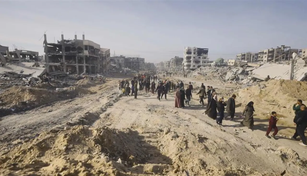People walking along a dusty road
