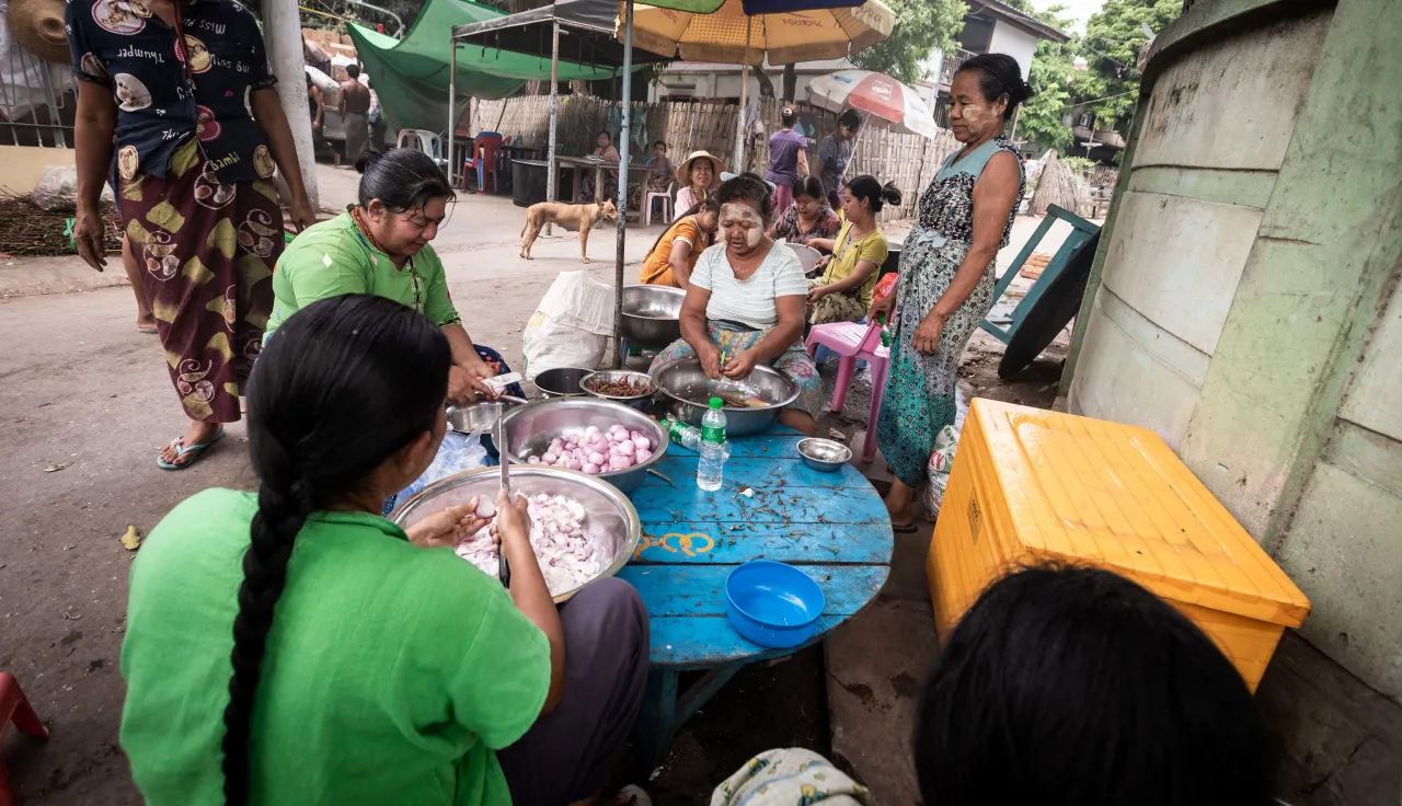 Sagaing, Myanmar, women cooking together in community kitchen 