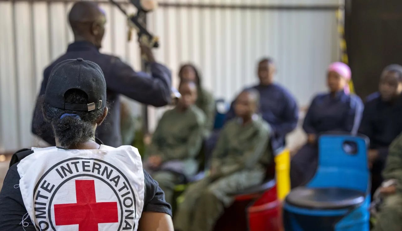 Law Students from a Kenyan University listen to an firearms instructer during an IHL War simulation in Nairobi, Kenya
