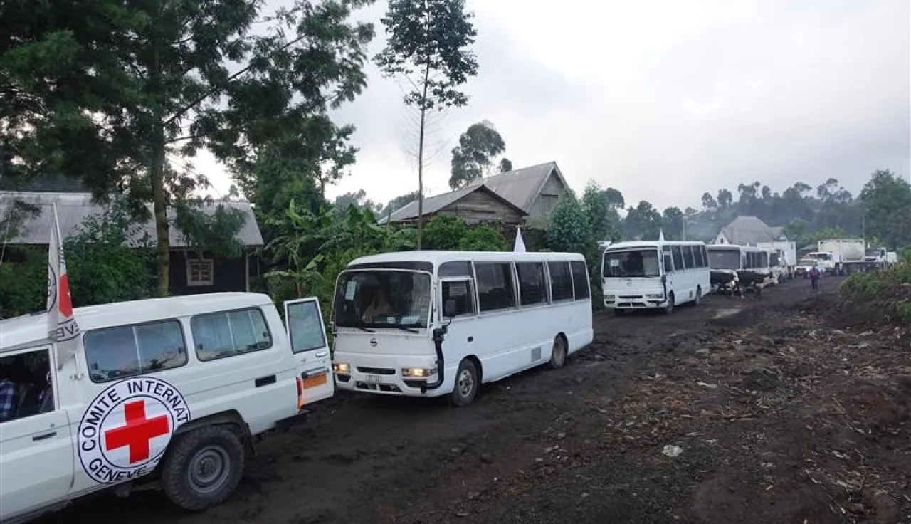 ICRC vehicles and white buses line up