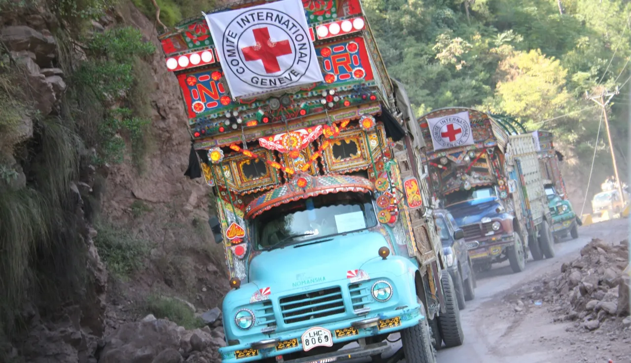 An ICRC convoy, decorated in traditional Pakistani style, transporting blankets and food, drive through a mountainous road in Jhelum Valley, Pakistan.
