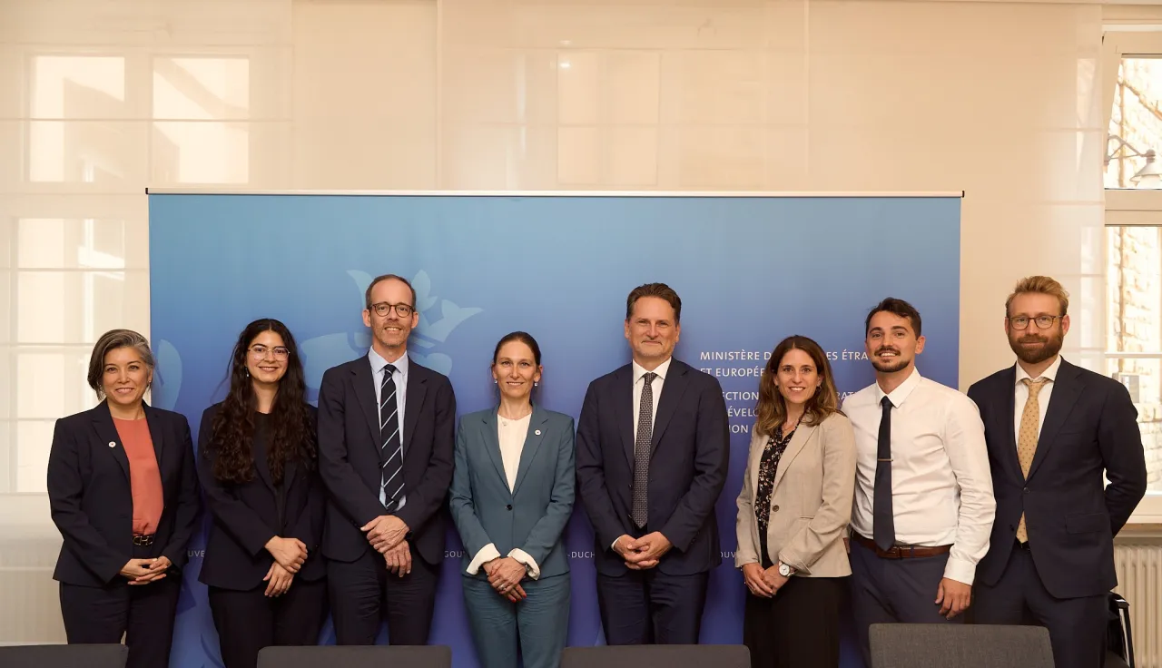 A group photo of eight representatives from the ICRC and Luxembourg MFA.