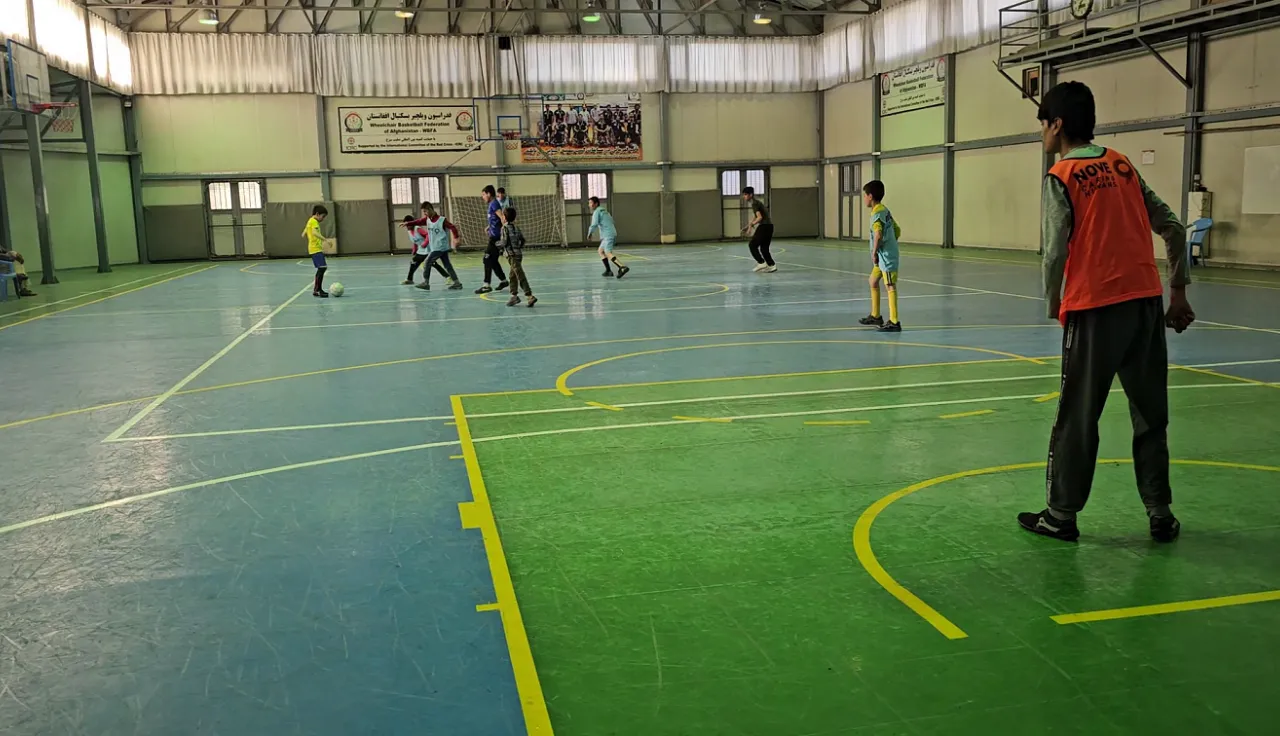 Children with disability playing in the futsal court at the ICRC's Physical Rehabilitation Centre in Kabul