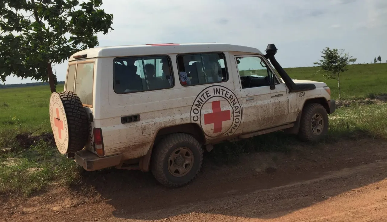 ICRC vehicle with emblem on the side and back parked on a road
