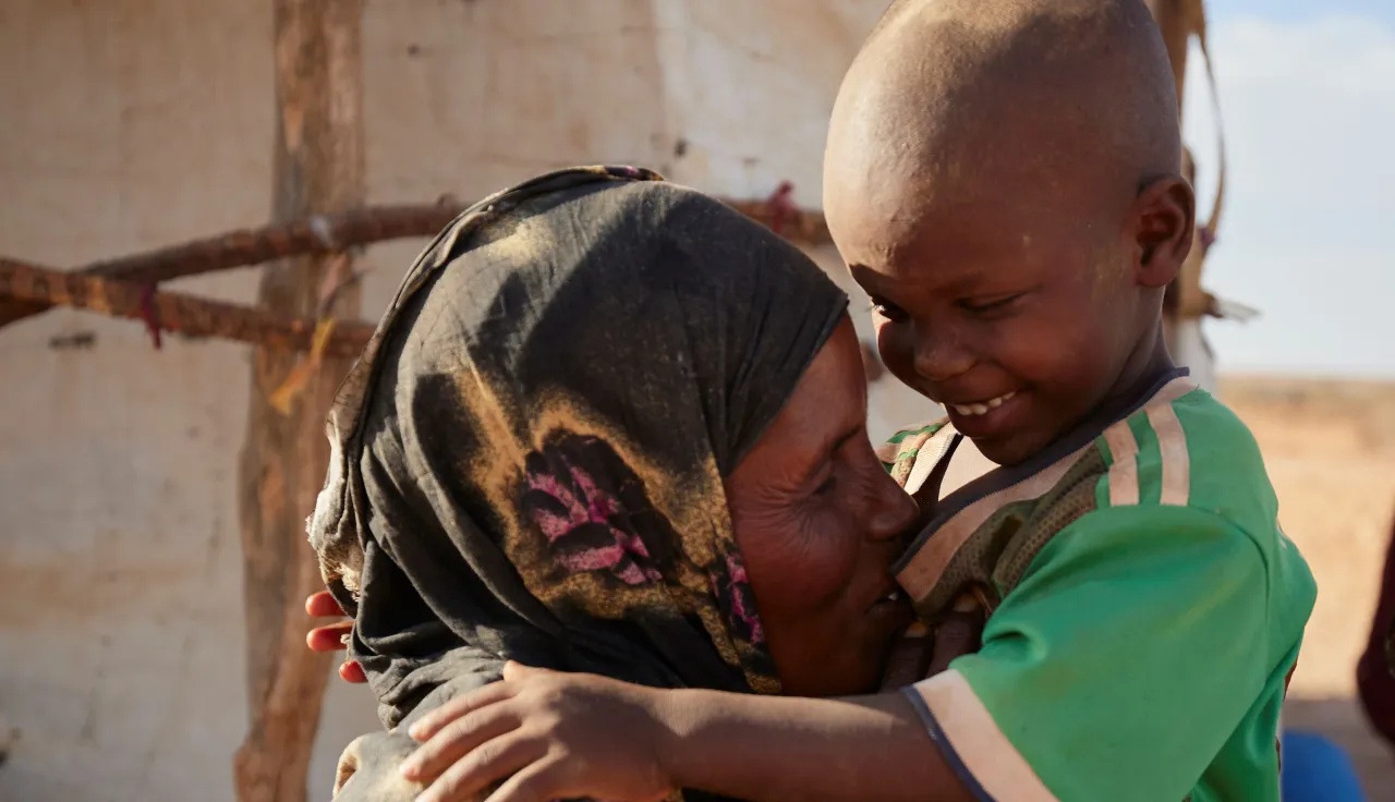 Somalia. Nadifa, her son and the rest of her family have been displaced because of armed conflict, and now live in makeshift shelters. The ICRC works with the Somali Red Crescent Society to provide them and other displaced people with support for meeting their basic needs and improving their living conditions.