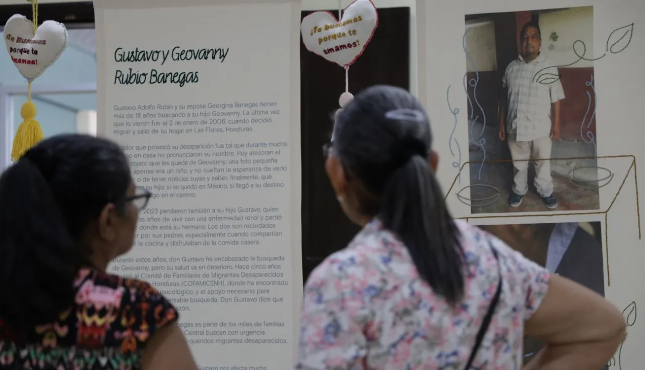 Dos personas son fotografiadas de espaldas mientras observan la exposición Tejer Memoria