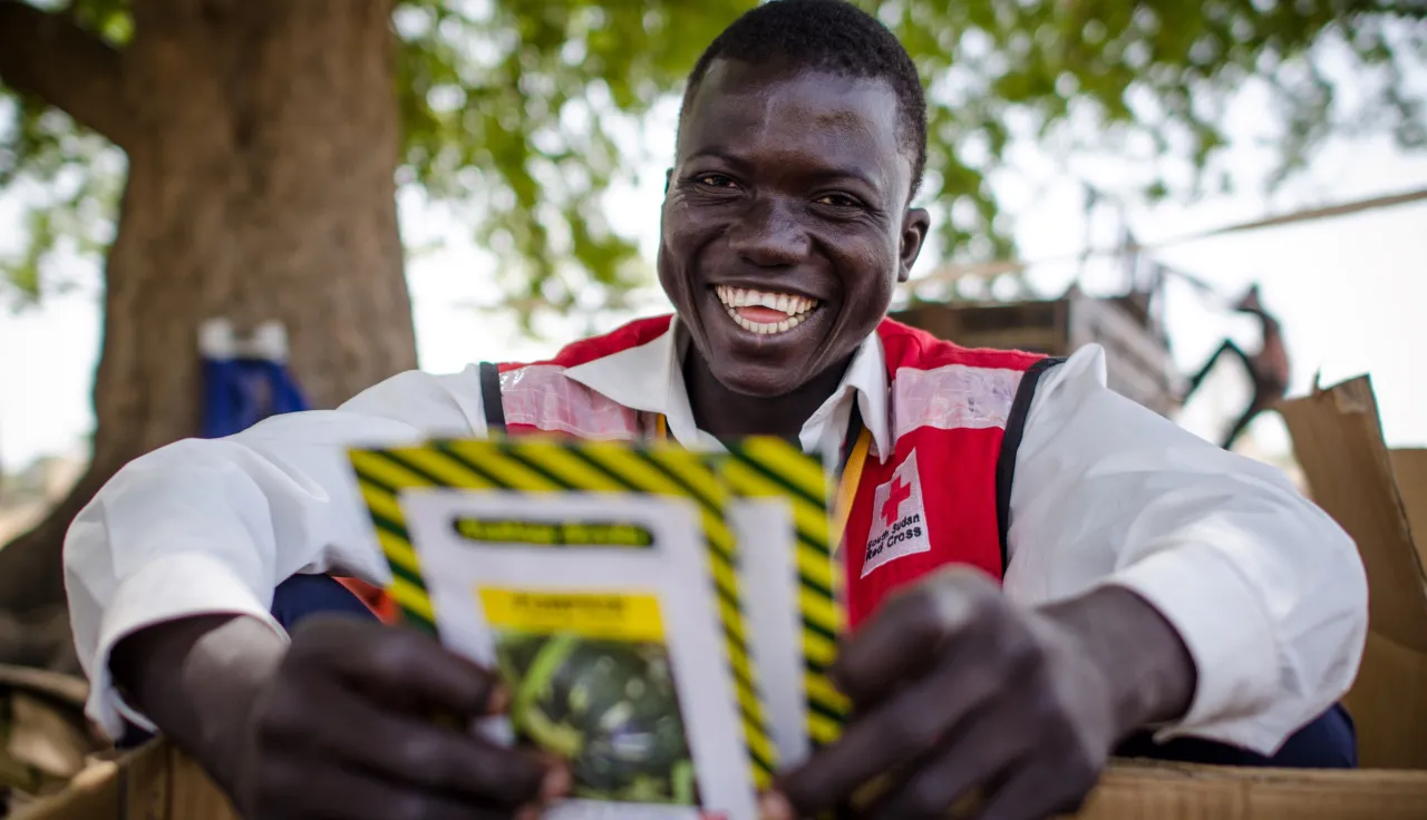 A South Sudan Red Cross volunteer shows seeds given out to women farmers in rural South Sudan to improve agriculture and food production in the onset of the rainy season.