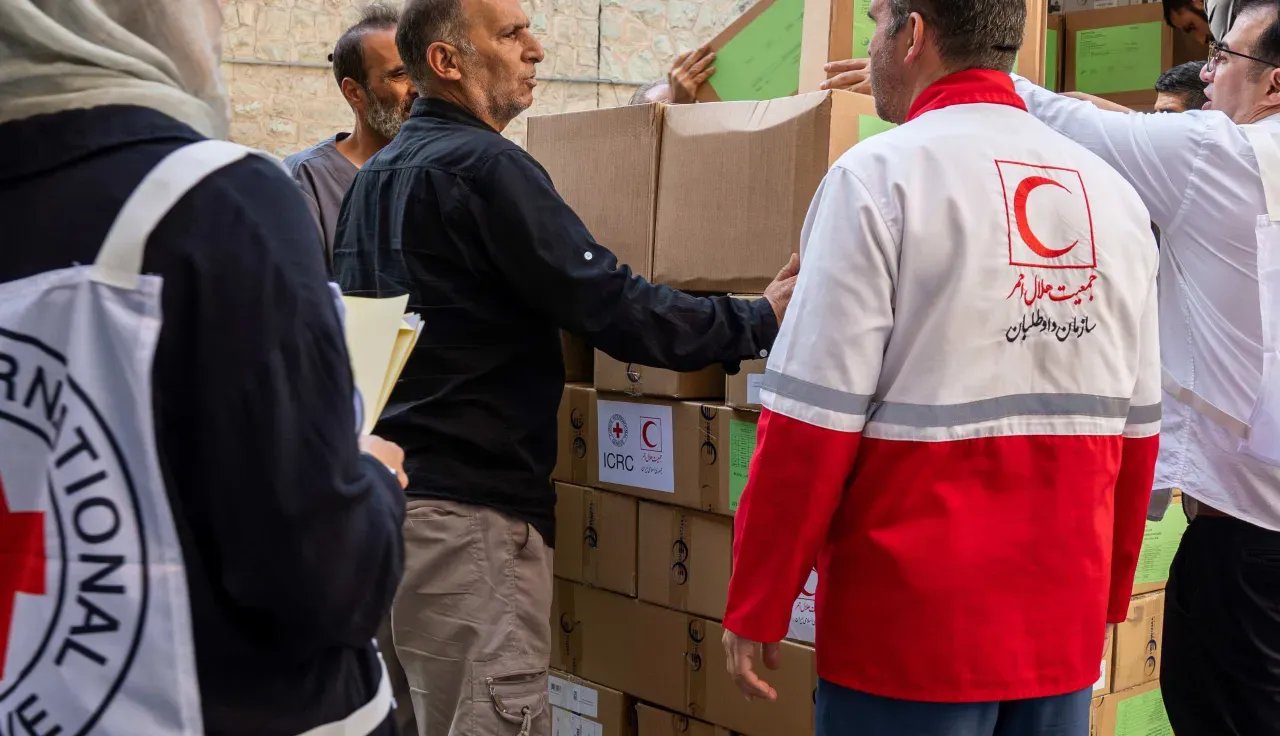 ICRC-and-Red-Crescent-staff-unload-boxes-of-humanitarian-supplies-from-a-truck-working-together-to-deliver-aid