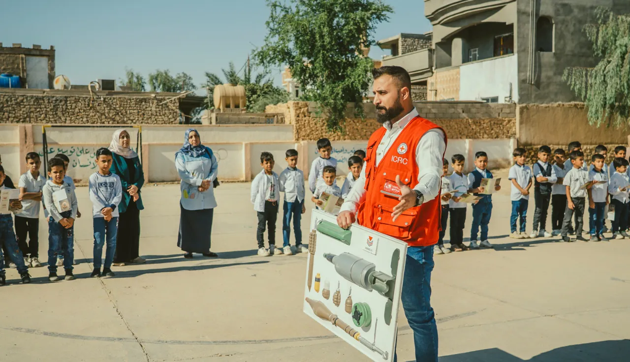 ICRC field officer giving awareness sessions about weapon contamination to school students