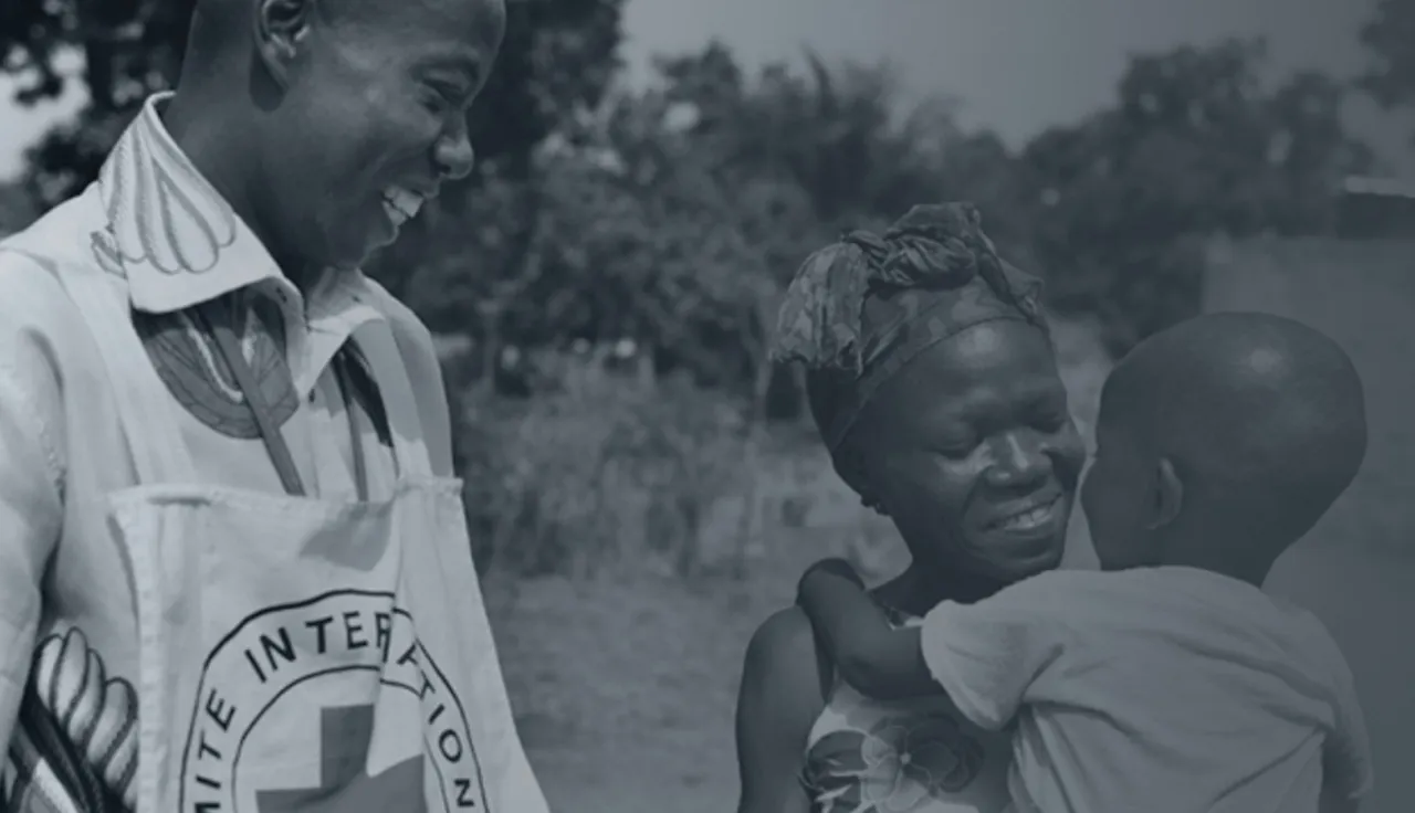 ICRC helps people in  conflict areas, woman helping some children 