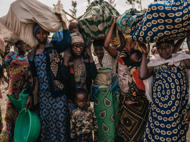 Community members flee to the town of Sake. After arriving to safety, displaced families must build shelter and search for food. Community members flee to the town of Sake. After arriving to safety, displaced families must build shelter and search for food.