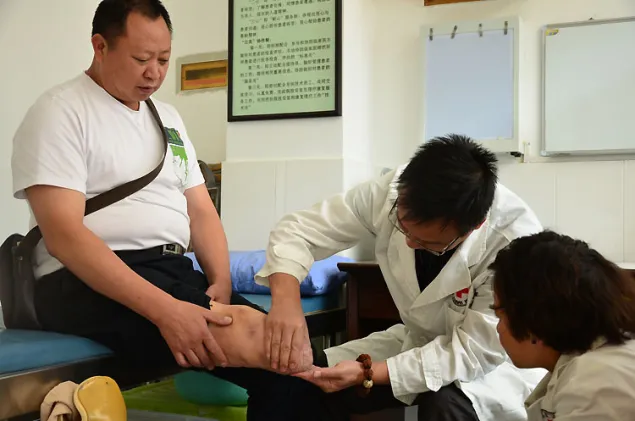 云南省红十字会假肢康复中心的工作人员为张丛发检查残肢。红十字国际委员会/云南省红十字会救助肢体残疾者合作项目是红十字国际委员会与中国红十字会合作，在中国境内实施的第一个实质性项目。自2004年1月启动以来，该项目共为云南省肢残人士提供免费服务6000余人/次。