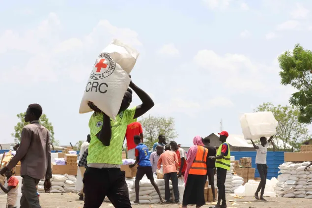 ICRC staff supplying essential items to refugees.