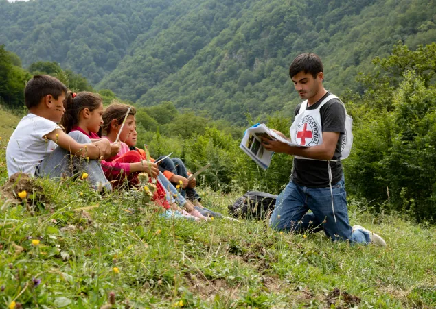 An ICRC staff member raising awareness on the dangers of mines and explosive remnants of war in the Dashkasan district, Azerbaijan.