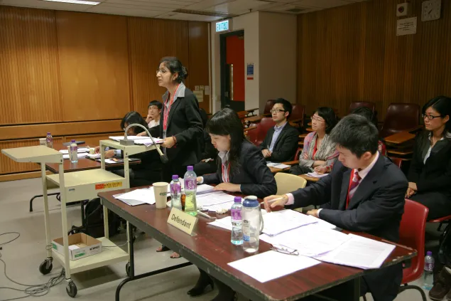 在法官面前,法律系3年级的学生加里玛•米特拉代表希达亚图拉国立法律大学与来自中国国际关系学院的同学们进行辩论。