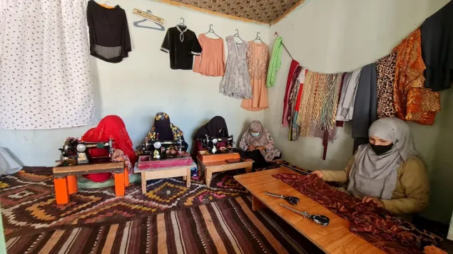 Nilofar Akbari (far right) and four other women working in a tailoring shop in Mazar-i-Sharif.