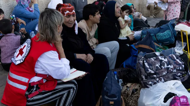 Photo showing Zakieh with her family and the luggage they carried from Lebanon
